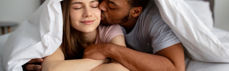 Black guy kissing his lover under a squirting blanket