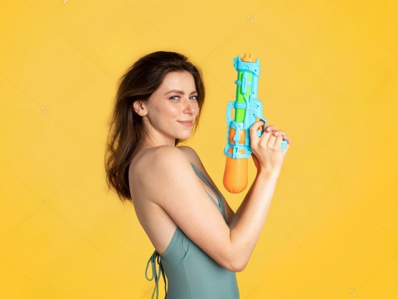 Attractive lady holding a water pistol